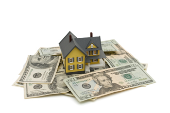 Yellow house on some American money isolated on white, Investing in a house